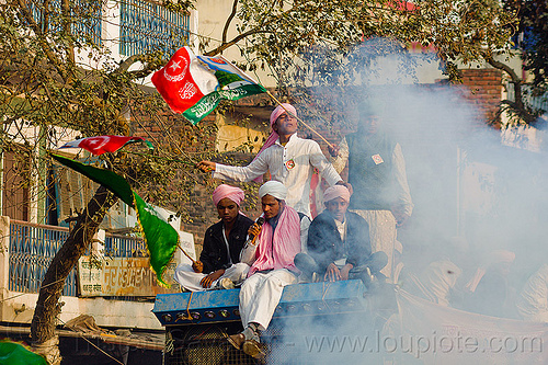 muslim men waving flags on truck roof - eid-milad-un-nabi muslim festival (india), crowd, eid e milad un nabi, eid e milād un nabī, flags, islam, mawlid, men, muhammad's birthday, muslim festival, muslim parade, nabi day, prophet's birthday, smoke, عید میلاد النبی, ईद मिलाद नबी