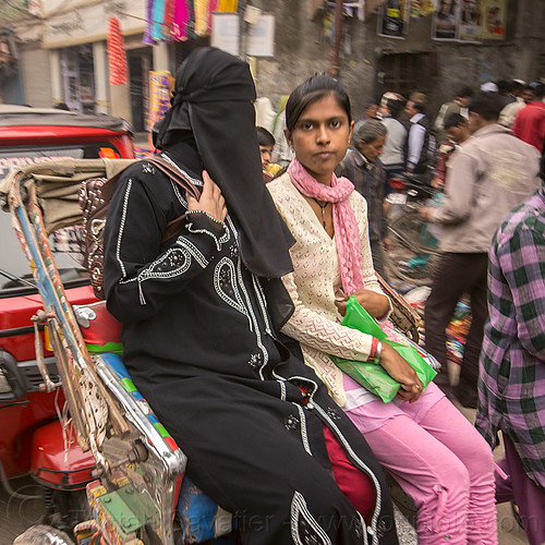 muslim woman in niqab, riding rickshaw with hindu woman, cycle rickshaw, hindu, indian woman, indian women, islam, muslim, niqab, varanasi