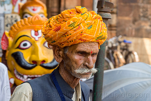 mustachioed hindu pilgrim at the lingaraja temple - bhubaneswar (india), bhubaneswar, headwear, hindu man, hindu temple, hinduism, indian man, lingaraj temple, lingaraja temple, mustache, painted, pilgrim, sculpture, stone tiger, tilak, tilaka, turban, yellow