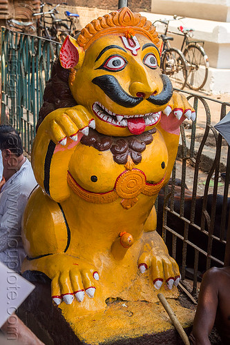 mustachioed stone tiger guarding hindu temple (india), bhubaneswar, hindu temple, hinduism, lingaraj temple, lingaraja temple, mustache, painted, sculpture, statue, sticking out tongue, sticking tongue out, stone tiger, tilak, tilaka, yellow