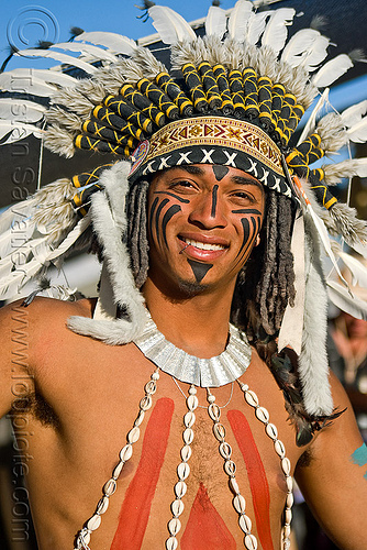 native american costume with feather headdress, attire, burning man outfit, face painting, facepaint, fashion show, feather headdress, feather headwear, feathers, indigenous costume, native american, necklace, seashells, tribal costume