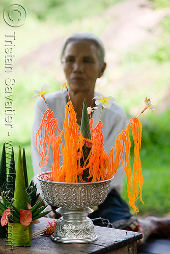 offering - wat phu champasak (laos), flower offerings, flowers, hindu temple, hinduism, khmer temple, old woman, orange, ruins, wat phu champasak, wool