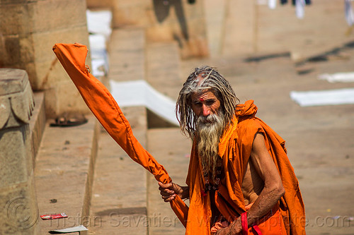old hindu man in saffron color cloth on the ghats of varanasi (india), baba, beard, bhagwa, dreadlocks, ghats, hindu, hinduism, old man, pilgrim, sadhu, saffron color, varanasi