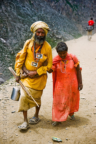 old hindu man with blind woman on trail - amarnath yatra (pilgrimage) - kashmir, amarnath yatra, beard, bhagwa, blind, hindu pilgrimage, hinduism, kashmir, mountain trail, mountains, old man, pilgrims, saffron color