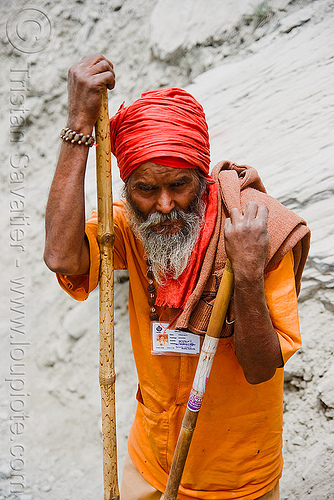 old hindu pilgrim resting - amarnath yatra (pilgrimage) resting on trail - kashmir, amarnath yatra, beard, bhagwa, headwear, hiking cane, hindu man, hindu pilgrimage, hinduism, kashmir, mountain trail, mountains, old man, pilgrim, resting, saffron color, walking stick