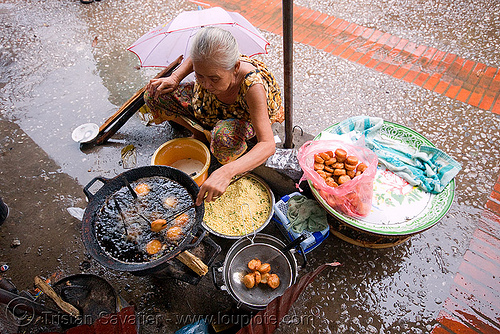 old woman cooking excellent little cakes in the market - luang prabang (laos), asian woman, cakes, cooking, deep frying, fire, frying oil, frying pan, luang prabang, mature woman, old, street food, street market, street seller, street vendor, wok