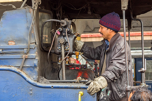 operator at the controls of a steam locomotive - darjeeling (india), 788 tusker, controls, darjeeling himalayan railway, darjeeling toy train, hydrostatic displacement lubricator, hydrostatic lubricator, man, mechanical lubricator, narrow gauge, operator, railroad, steam engine, steam locomotive, steam train engine