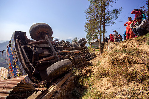 overturned truck lands on village house (nepal), crash, ditch, lorry, mountain road, overturned, rollover, tata motors, traffic accident, truck accident, underbelly, up-side-down, wreck