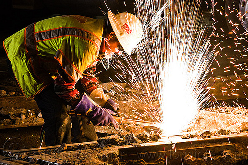 oxy-acetylene cutting torch, high-visibility jacket, high-visibility vest, light rail, man, muni, night, ntk, oxy-acetylene cutting torch, oxy-fuel cutting, railroad construction, railroad tracks, railway tracks, reflective jacket, reflective vest, safety glasses, safety gloves, safety helmet, safety vest, san francisco municipal railway, sparks, track maintenance, track work, welder, worker, working