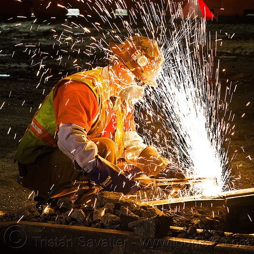 oxy-acetylene cutting torch, dust mask, high-visibility jacket, high-visibility vest, light rail, man, muni, night, ntk, oxy-acetylene cutting torch, oxy-fuel cutting, railroad construction, railroad tracks, railway tracks, reflective jacket, reflective vest, safety glasses, safety helmet, safety vest, san francisco municipal railway, sparks, track maintenance, track work, welder, worker, working