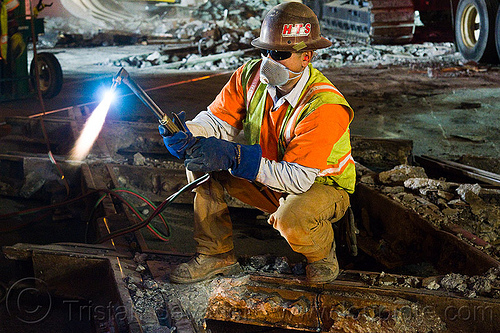 oxy-acetylene torch, blue flame, fire, high-visibility jacket, high-visibility vest, light rail, man, muni, night, ntk, oxy-acetylene cutting torch, oxy-fuel cutting, railroad construction, railroad tracks, railway tracks, reflective jacket, reflective vest, safety helmet, safety vest, san francisco municipal railway, track maintenance, track work, welder, worker, working