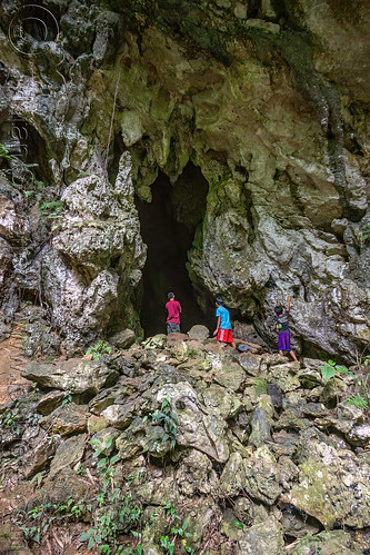 people at mouth of natural cave, tana toraja