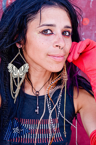 photo of mumu and her butterfly earring, butterfly earring, feather earring, key necklace, nose piercing, puerto rican flag, puerto rico flag, septum piercing, woman