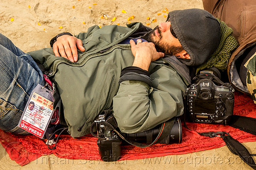 photographer jordano cipriani - kumbh mela 2013 (india), cameras, hindu pilgrimage, hinduism, jordano cipriani, kumbh mela, laying down, man, napping, press pass, press photographer, resting, sleeping