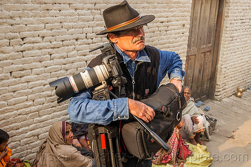 photographer with canon camera and tripod, canon camera, fedora hat, hindu, hinduism, kathmandu, maha shivaratri, man, pashupatinath, photographer, telephoto lens, tripod