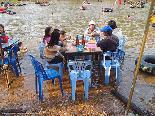 picnicking on the beach - river fair - tha ton - near fang (thailand), beach, fair, family, inner tubes, picnic, picnicking, plastic chairs, river bathing, river tubing, sitting, songkran, table, tha ton, thailand, สงกรานต์