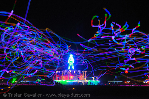 playa flies in front of the man - burning man 2006, burning man at night, chinchilla camp, glowing, led lights, michael brown, playa flies