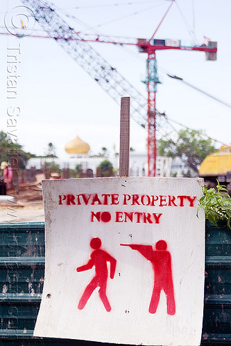 private property - no entry, armed guard, borneo, construction site, construction zone, cranes, gun, malaysia, no entry, no trespassing, private property, security guard, stencil, warning sign
