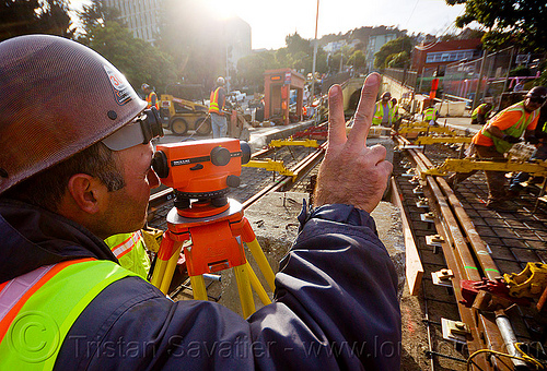 railroad construction survey - level, construction workers, duboce, geometer, high-visibility jacket, high-visibility vest, light rail, men, muni, ntk, railroad construction, railroad tracks, railway tracks, reflective jacket, reflective vest, safety helmet, safety vest, san francisco municipal railway, survey level, surveyor, track maintenance, track work, tripod, working