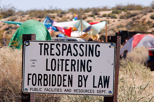 rave party in the desert, dancing, no trespassing, public facilities and resources dept., sign, trespassing loitering forbidden by law, video in use