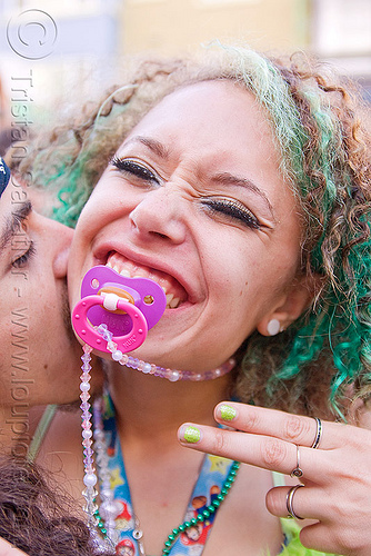 raver girl with binky, binky, gay pride festival, green hair, kathleen, man, neck kiss, necklace, pacifier, woman