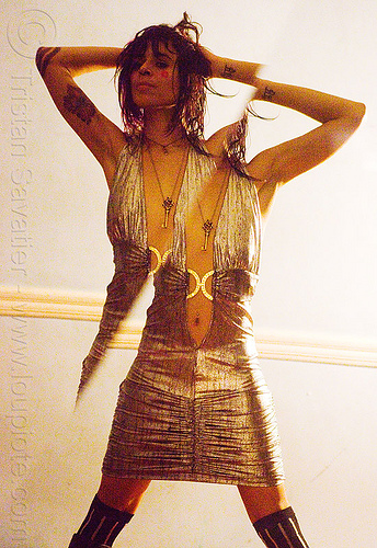 reflection in a broken mirror, arm tattoos, broken image, broken mirror, diagonal, key necklace, silver dress, woman