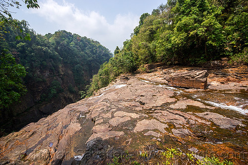 rocky river bed at top of large waterfall near mawlynnong (india), east khasi hills, jungle, mawlynnong waterfall, meghalaya, mountains, rain forest, river bed, rock