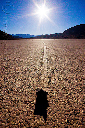 sailing rock on the racetrack with sun backlight - death valley, backlight, cracked mud, death valley, dry lake, dry mud, landscape, mountains, racetrack playa, rock, sailing stones, sliding rocks, sun