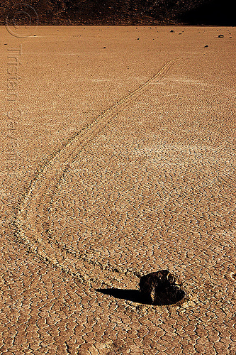 sailing stone curved track on the racetrack - death valley, cracked mud, death valley, dry lake, dry mud, racetrack playa, rock, sailing stones, sliding rocks