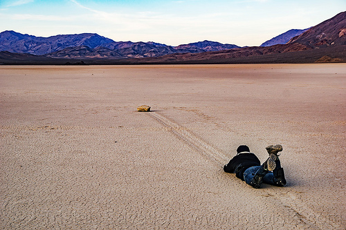 sailing stone on the racetrack - death valley, cracked mud, death valley, dry lake, dry mud, landscape, mountains, racetrack playa, sailing stones, sliding rocks, woman