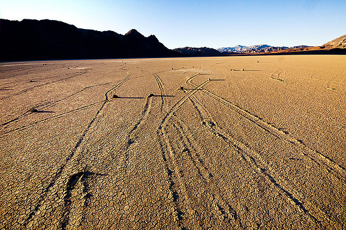 sailing stones with crisscrossing tracks - racetrack - death valley, cracked mud, death valley, dry lake, dry mud, mountains, racetrack playa, sailing stones, sliding rocks