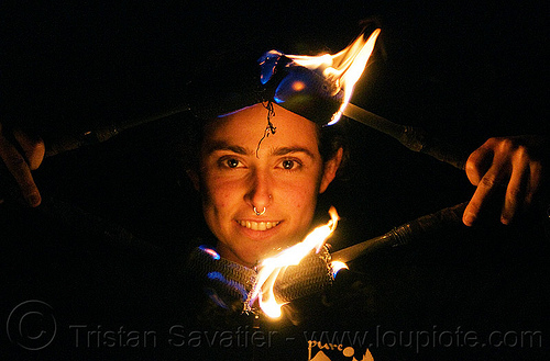 sarah spinning fire nunchaku, fire dancer, fire dancing, fire nunchaku, fire performer, fire spinning, night, nose piercing, sarah, septum piercing, woman