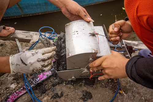 scientists using a dredge sampler in the makassar harbor, day grab, dredge sampler, makassar