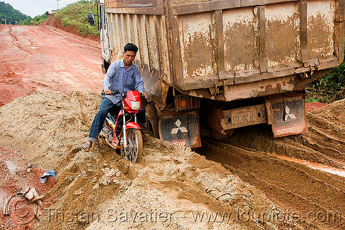 scooter and truck stuck in mud (laos), laos, lorry, mud, rider, riding, road, ruts, truck, underbone motorcycle