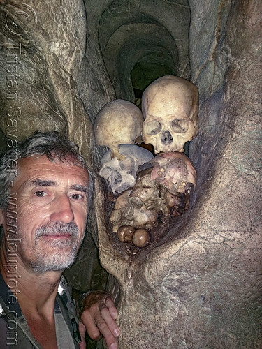 selfie with skulls in londa burial cave - tana toraja, burial site, cemetery, grave, graveyard, human bones, human skulls, kulls, liang, londa burial cave, londa cave, man, selfie, tana toraja, tomb