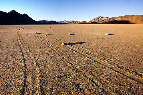 several sailing stones and their tracks - racetrack (death valley), cracked mud, death valley, dry lake, dry mud, landscape, mountains, racetrack playa, sailing stones, sliding rocks