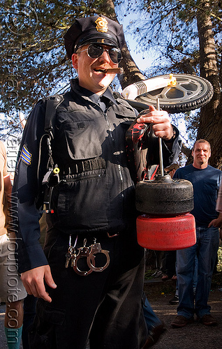 sfpd police officer - byobw - "bring your own big wheel" race - toy tricycles (san francisco), big wheel, cigar smoking, drift trikes, handcuffs, law enforcement, police officer, potrero hill, race, sfpd, toy tricycle, toy trike, trike-drifting, uniform