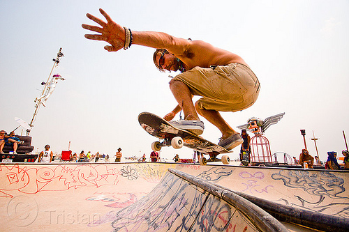 skateboarder jumping at skate park - burning man 2013, airborne, burning man, hand, heart bowl, jump, sk8 kamp, skate camp, skate park, skateboard park, skateboarder, skateboarding