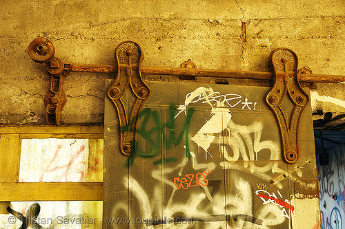 sliding door wheels, derelict, fire door, graffiti, rail, railing, sliding door, street art, tie's warehouse, trespassing