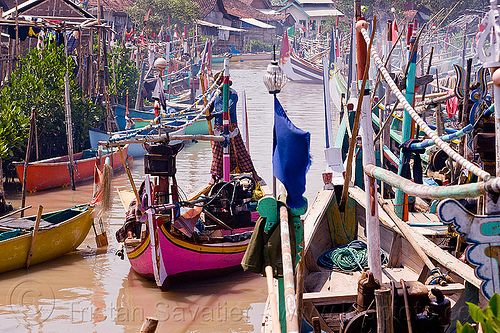 small fishing boats in fishing village - tamansarari, near probolingo (java), fisherman, fishing boats, fishing village, flags, man, mooring, ropes, sailing, small boats, steering, tamansari