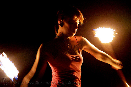 spinning fire staffs - fire dancer (san francisco) - leah, backlight, double staff, fire dancer, fire dancing, fire performer, fire spinning, fire staffs, fire staves, leah, night, spinning fire, tattooed, tattoos, woman