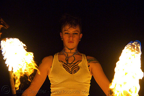 spinning fire staffs (san francisco) - fire dancer - leah, double staff, fire dancer, fire dancing, fire performer, fire spinning, fire staffs, fire staves, leah, night, spinning fire, tattooed, tattoos, woman