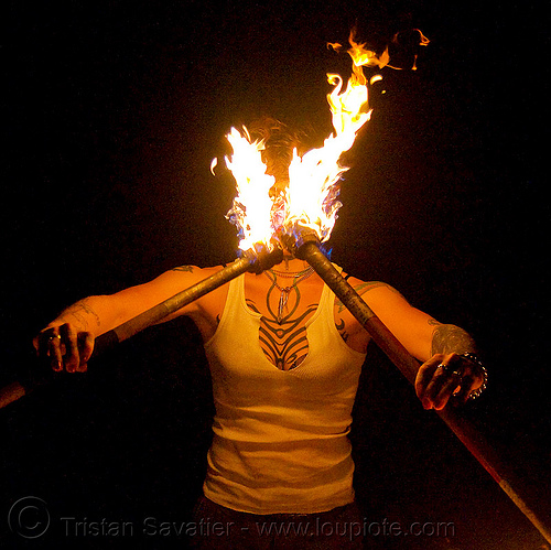 spinning fire staffs (san francisco) - fire dancer - leah, double staff, fire dancer, fire dancing, fire performer, fire spinning, fire staffs, fire staves, leah, night, spinning fire, tattooed, tattoos, woman