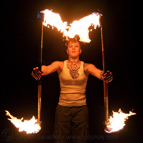 spinning fire staffs (san francisco) - fire dancer - leah, double staff, fire dancer, fire dancing, fire performer, fire spinning, fire staffs, fire staves, leah, night, spinning fire, tattooed, tattoos, woman