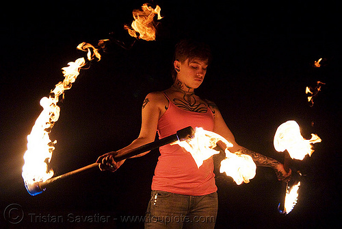 spinning fire staffs (san francisco) - fire dancer - leah, double staff, fire dancer, fire dancing, fire performer, fire spinning, fire staffs, fire staves, leah, night, spinning fire, tattooed, tattoos, woman