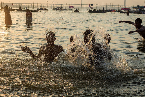 splashing water - hindu devotees taking holy dip in ganges river (india), backlight, bathing pilgrims, ganga, ganges river, hindu pilgrimage, hinduism, holy bath, holy dip, kumbh mela, nadi bath, river bank, river bathing, splash, splashing, triveni sangam