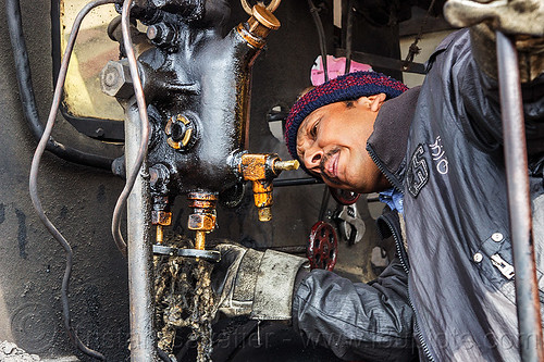 steam locomotive operator adjusting hydrostatic lubricator (india), 788 tusker, controls, darjeeling himalayan railway, darjeeling toy train, hydrostatic displacement lubricator, hydrostatic lubricator, man, mechanical lubricator, narrow gauge, operator, railroad, steam engine, steam locomotive, steam train engine, valves, worker, working