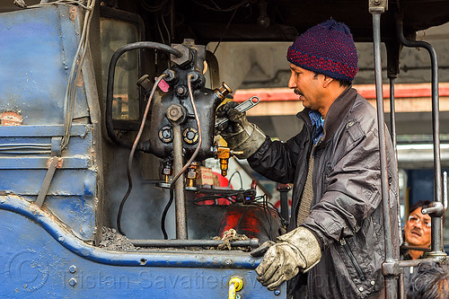 steam locomotive operator adjusting hydrostatic lubricator with adjustable wrench - darjeeling (india), 788 tusker, controls, darjeeling himalayan railway, darjeeling toy train, hydrostatic displacement lubricator, hydrostatic lubricator, man, mechanical lubricator, narrow gauge, operator, railroad, steam engine, steam locomotive, steam train engine, valves, worker, working, wrench