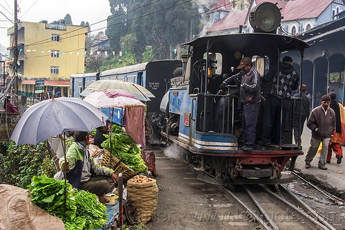 steam train departing from darjeeling (india), 782 mountaineer, darjeeling himalayan railway, darjeeling toy train, farmers market, men, narrow gauge, operator, railroad, salads, stall, steam engine, steam locomotive, steam train engine, street market, street seller, train cars, train station, umbrellas, vegetables, vendors