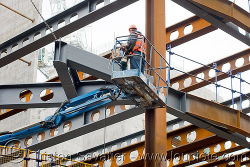steel frame building construction - steel beams - the walbrook (london), aerial lift, boom lift, building construction, cherry picker, construction worker, crane, high-visibility jacket, high-visibility vest, london, reflective jacket, reflective vest, safety harness, safety helmet, steel beams, steel frame